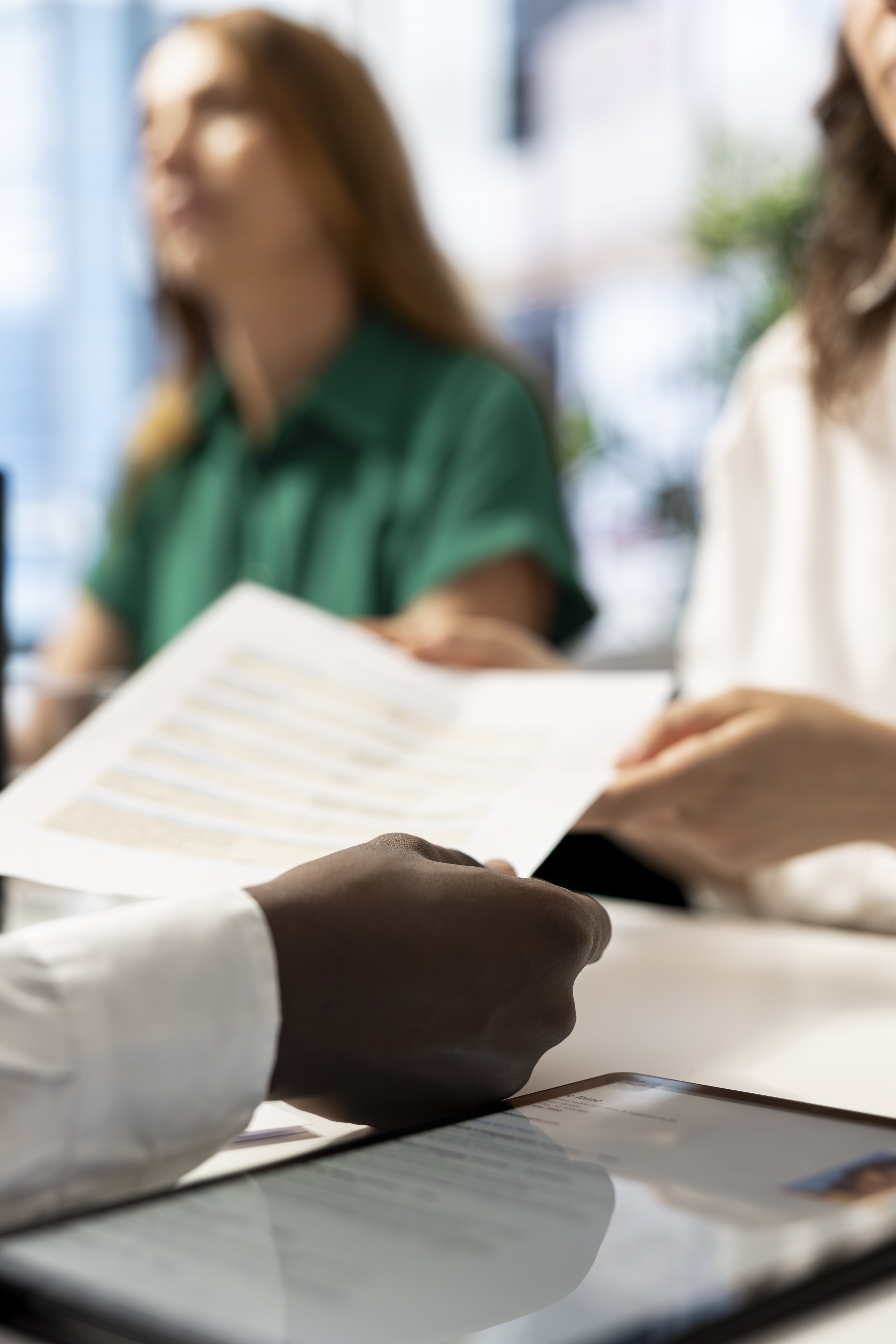 document in hand in a meeting