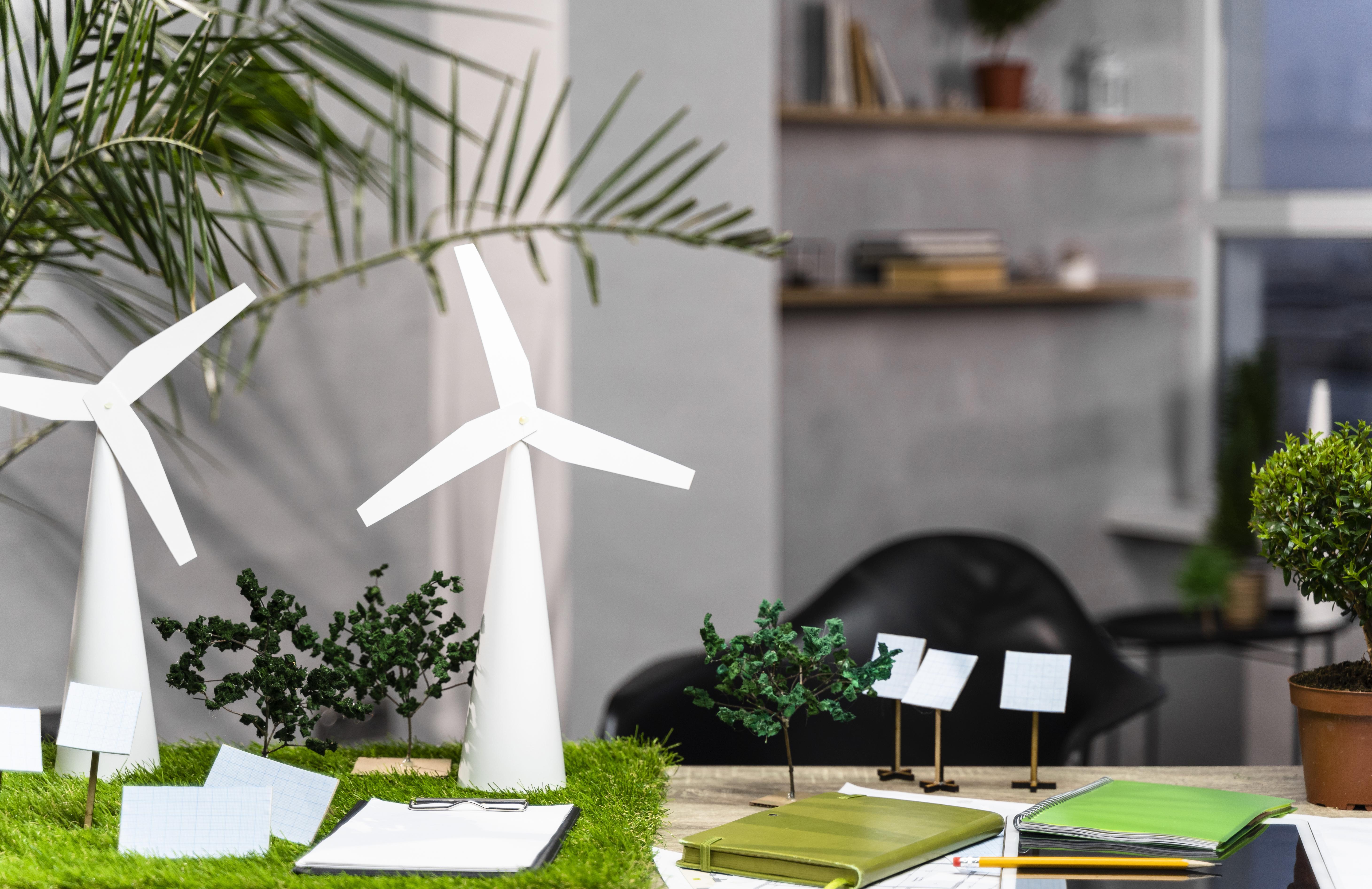 Front view of an eco-friendly wind power project layout with wind turbines on desk.